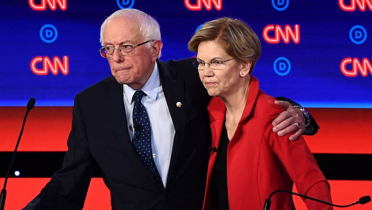 Sens. Bernie Sanders and Elizabeth Warren are shown in a file photo from a Democratic debate. (Photo by Brendan Smialowski / AFP)