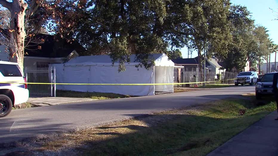 A tent is set up outside a house on Harding Street where a deadly raid took place last year.