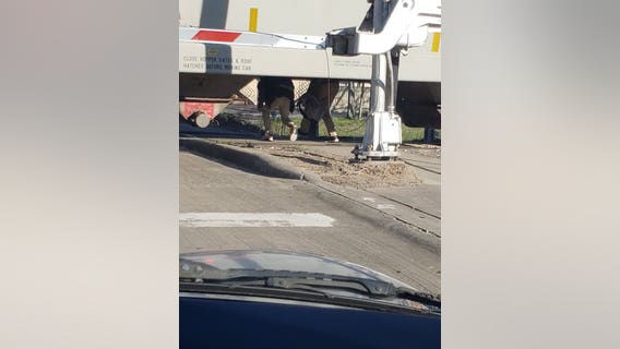 Fifth Ward students seen crawling through stopped train cars going to and from school