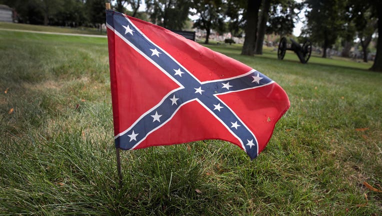 A Confederate flag is shown in the grass. (Photo by Scott Olson/Getty Images)