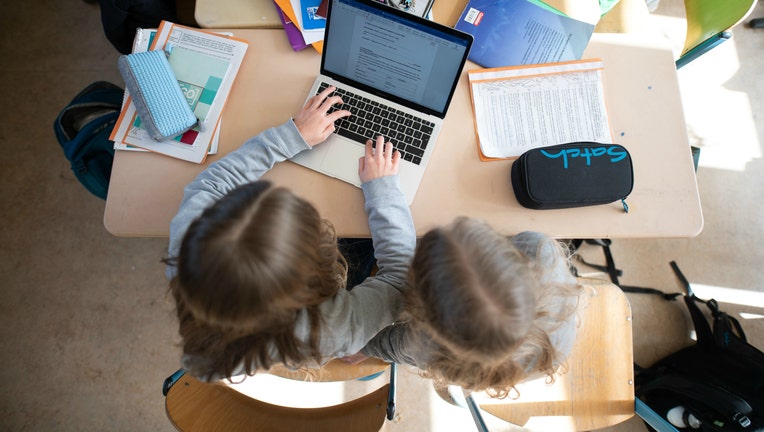 GETTY Girls children students laptops learning