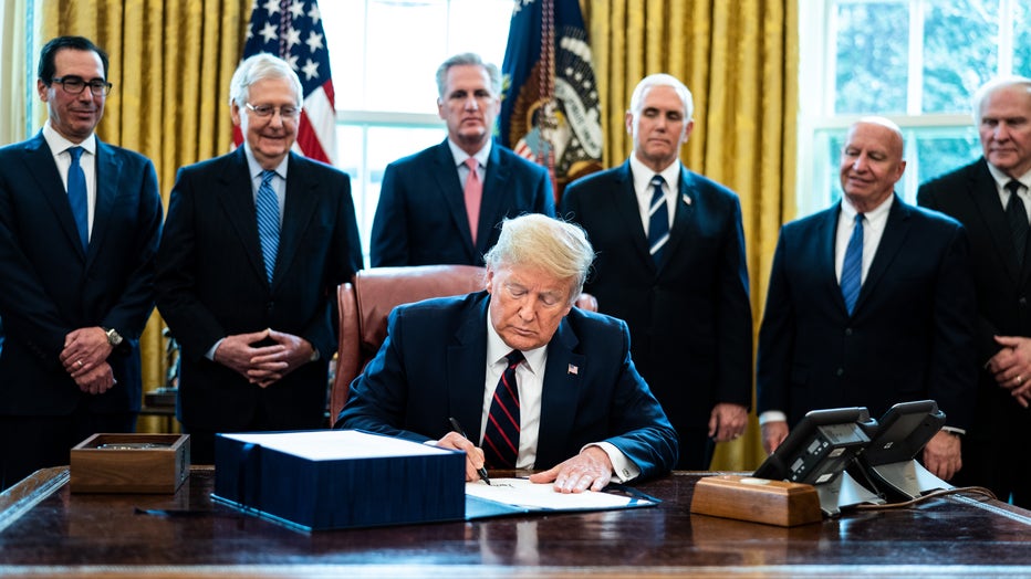 d26de78f-President Trump Signs Coronavirus Stimulus Bill In The Oval Office