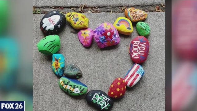 Family paints rocks for senior citizens