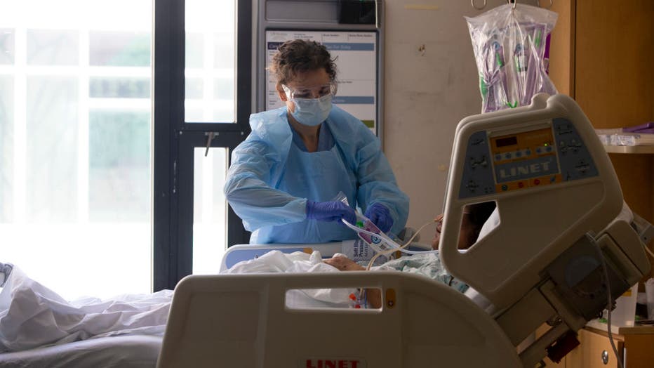 8d52feeb-Health Care Professionals Treat Coronavirus Patients On The Acute Care Floor Of Harborview Medical Center