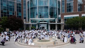 Healthcare professionals kneel in solidarity with protesters against racial inequality