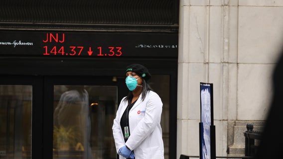 Dow sinks 1,800 as virus cases rise, deflating optimism