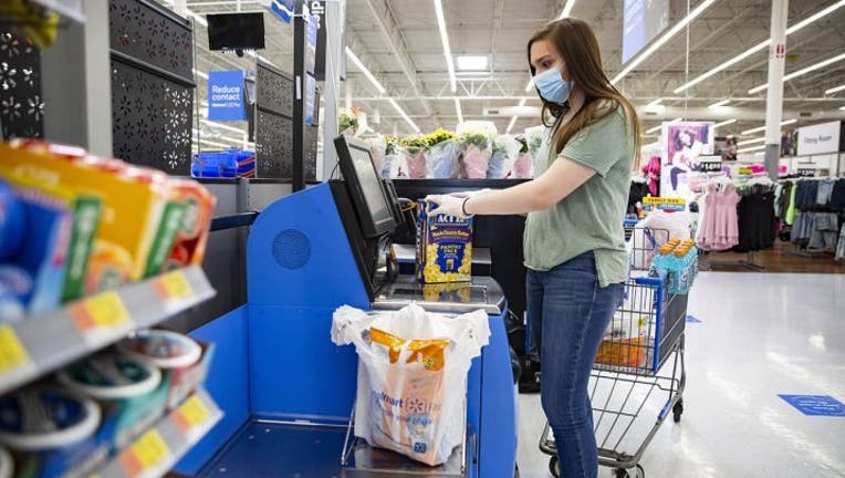 customer-at-self-checkout-side-view