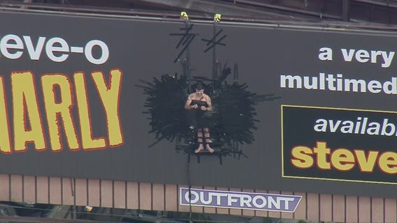 LAFD responds to unusual call for service after man tapes himself to billboard in publicity stunt