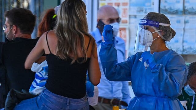 Vacationers, migrants drive Italy's surge in COVID-19 cases