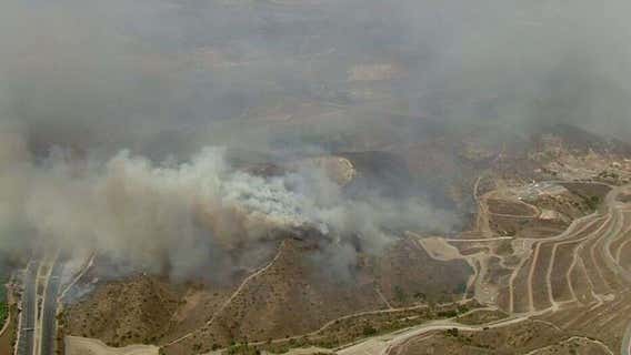 Fast-moving wildfire forces evacuation of over 90,000 in Southern California