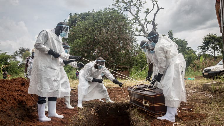 (EDITORS NOTE: Image depicts death)
Health workers wearing