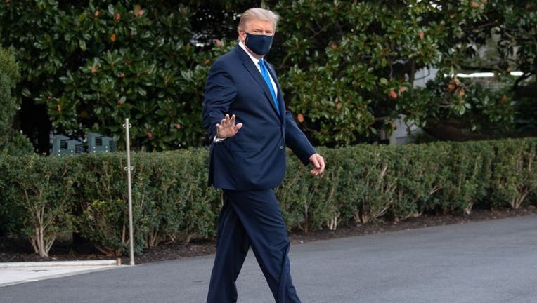 US President Donald Trump waves as he walks to Marine One prior to departure from the South Lawn of the White House in Washington, DC, October 2, 2020, as he heads to Walter Reed Military Medical Center, after testing positive for Covid-19. - President Donald Trump will spend the coming days in a military hospital just outside Washington to undergo treatment for the coronavirus, but will continue to work, the White House said Friday.