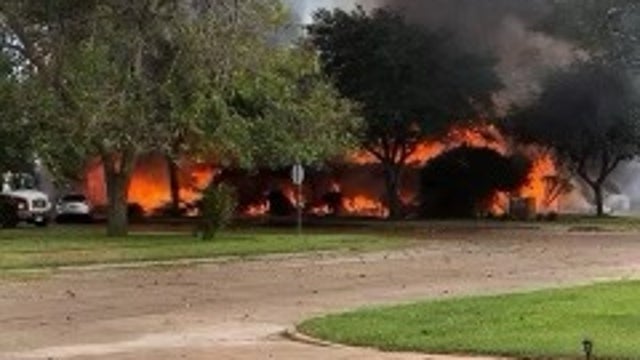 Officials working to put out flames at Bay City funeral home