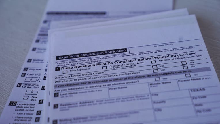 FILE: A stack of Texas voter registration forms on July 31, 2020.