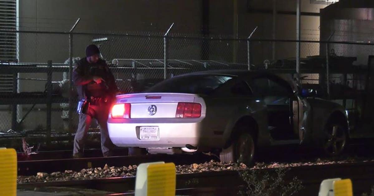 Police chase ends with driver stuck on railroad tracks in downtown ...