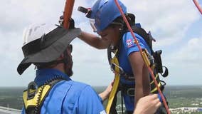 FOX 26 staff goes 'over the edge' of Woodlands Tower to support camp for all
