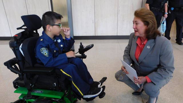 Boy bullied, pushed out of wheelchair at school for dressing as police officer becomes honorary member