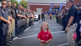 Watch: Police escort daughter of late officer to first day of school