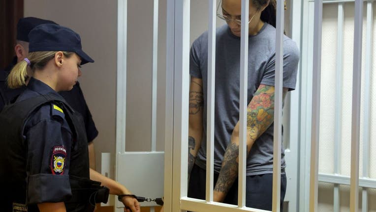 Brittney Griner stands inside a defendants' cage before a court hearing in Khimki outside Moscow, on August 4, 2022.