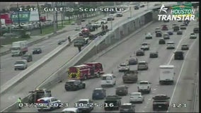 Trailer hangs from overpass along I-45 Gulf Freeway in Houston