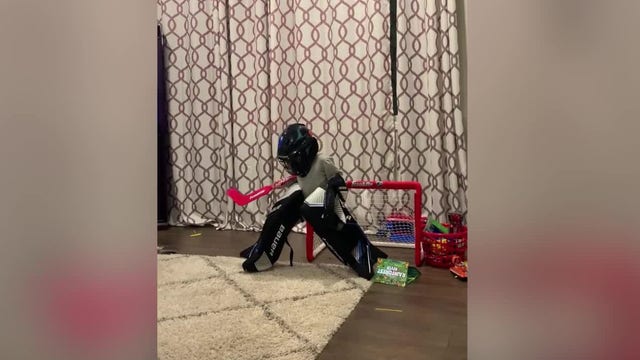 Young girl tries on brother's hockey pads, falls over: Video