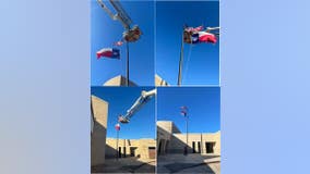 Crosby firefighters help elementary school replace flags damaged during Monday storms