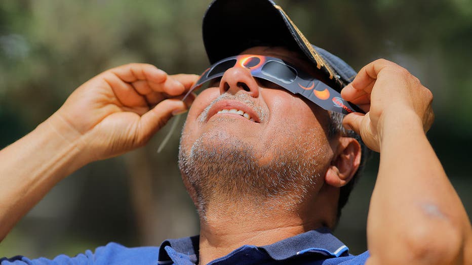 A man wears special glasses to observe the Great North American Eclipse ahead of tomorrows eclipse on April 7, 2024 in Torreon, Mexico. (Photo by Manuel Guadarrama/Getty Images)