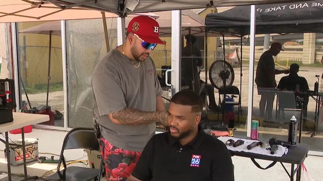 Empire Barber Studio cutting hair in parking lot due to power outage, storm damage