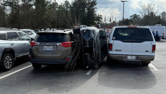 The Woodlands rollover: Driver loses control attempting to park vehicle, ends up on side between two vehicles