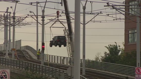 Jeep stuck on METRORail tracks in Houston lifted away by crane