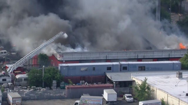 Houston fire: Firefighters contain large building fire near North Freeway, 1 firefighter injured