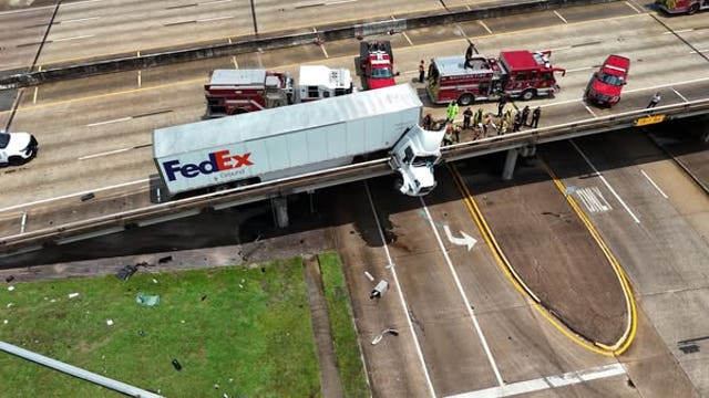 Southbound SH-146 shut down as part of 18-wheeler hangs from overpass