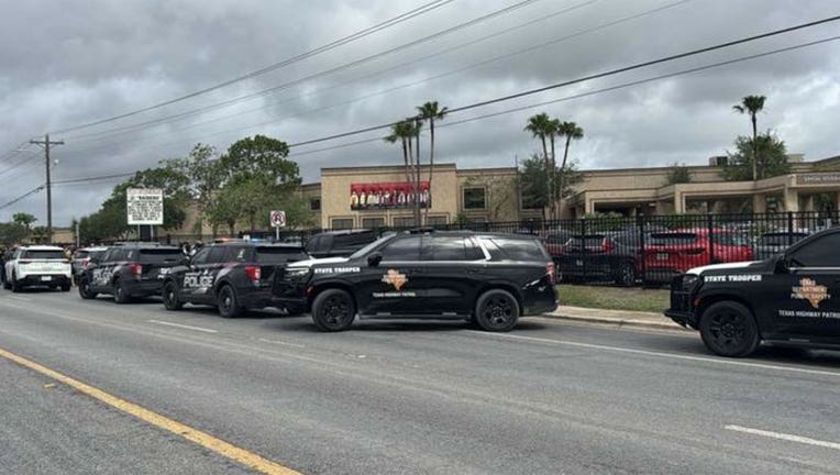 Authorities swarm a street in front of Rivera Early College High School in Brownsville, Texas, on April 21, 2026.