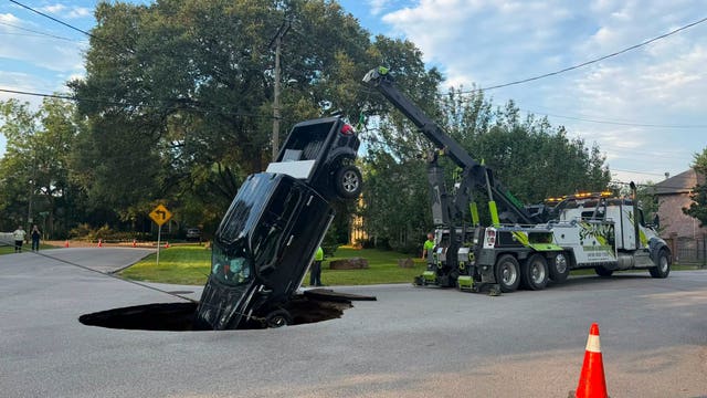 Pickup truck swallowed by road collapse following major water main break in Beaumont
