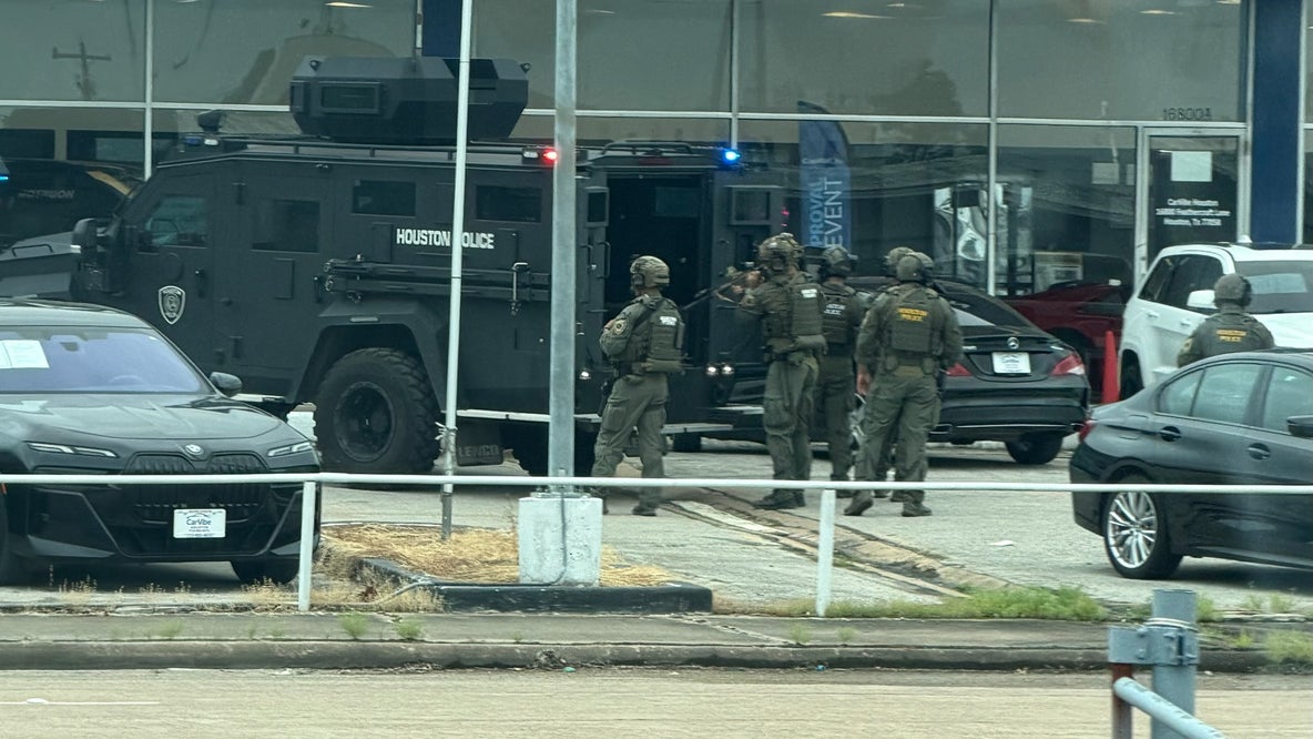 Houston SWAT, HPD serve warrant at used car dealership near Webster