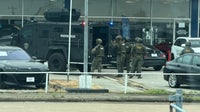 Houston SWAT, HPD serve warrant at used car dealership near Webster