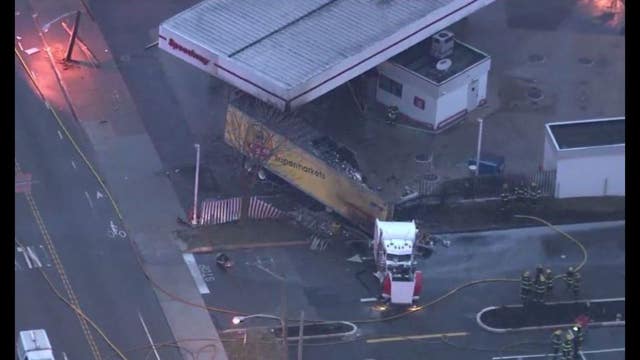 Truck crashes at gas station, brings down wires, catches fire