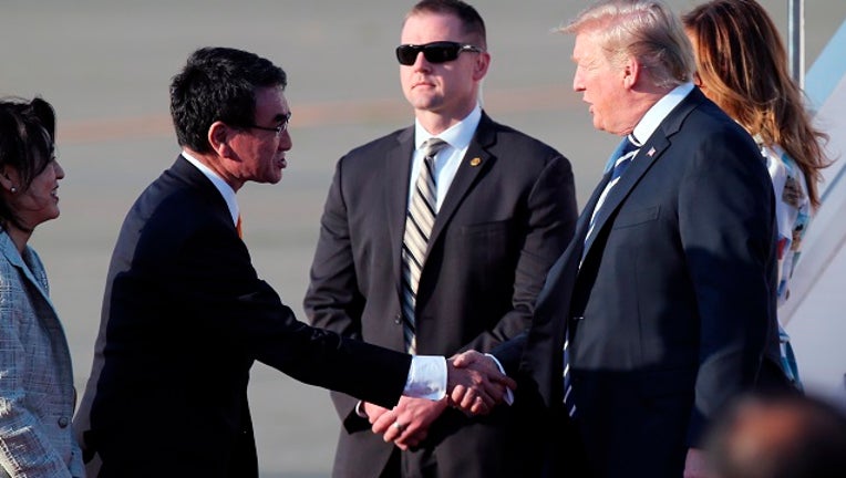 TOKYO, JAPAN - MAY 25: U.S. President Donald Trump (R) and Japanese Foreign Minister Taro Kono shake hands at Haneda International Airport on May 25, 2019 in Tokyo, Japan. (Photo by Koji Sasahara - Pool/Getty Images)