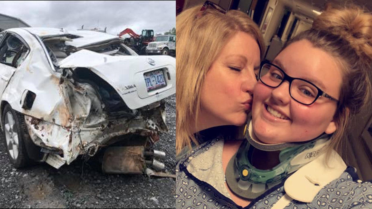 Wrecked car; mom kisses daughter