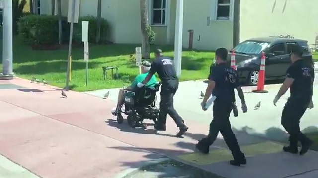 Firefighter pushes elderly man's broken down electric wheelchair back home