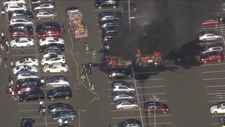 Skyfox over cars on fire at Franklin Mills Mall parking lot Friday.