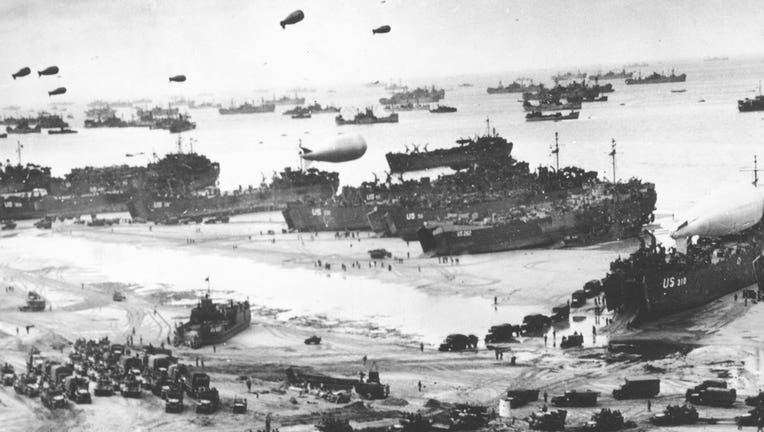 Fleets of ships and barrage balloons are shown in Normandy in a black and white July 14, 1944 photo.