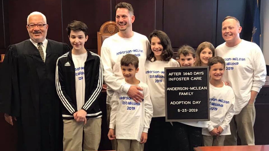 Steve and Rob Anderson-McLean are pictured with their six children and the judge.