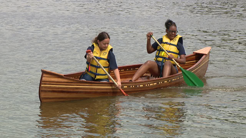 Students with Urban BoatWorks launch handcrafted boats on Cooper River Lake.