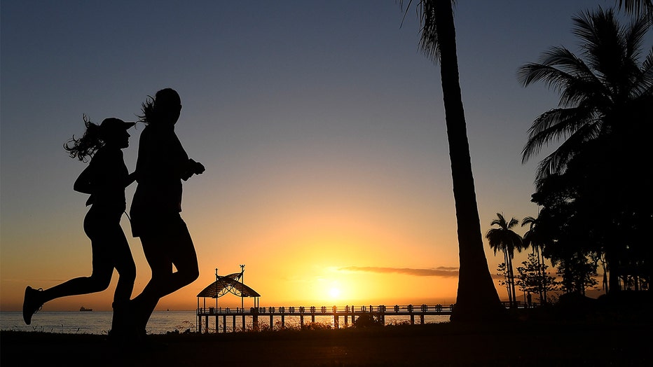  Two women are seen running along the Townsville Strand at sunrise in Townsville, Australia.