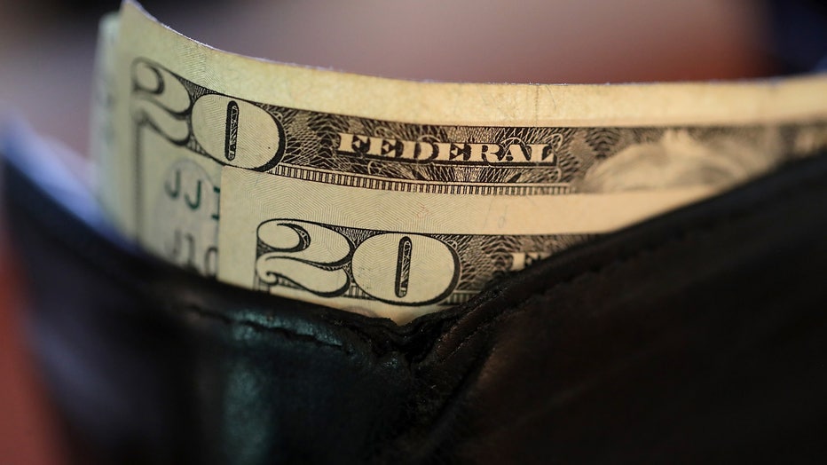 In this file photo, twenty dollar bills sit in a wallet on August 29, 2017 in San Anselmo, California. (Photo Illustration by Justin Sullivan/Getty Images)