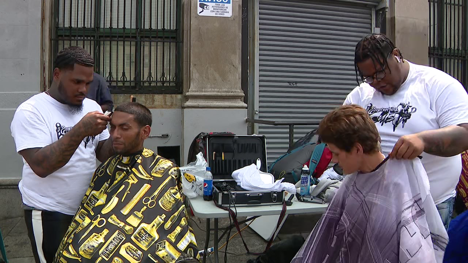 Joshua Santiago cuts hair in a fundraiser known as the 24 Hour Haircut 4 the Homeless in Kensington.