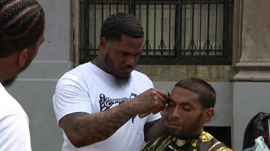 Joshua Santiago cuts hair in a fundraiser known as the 24 Hour Haircut 4 the Homeless in Kensington.