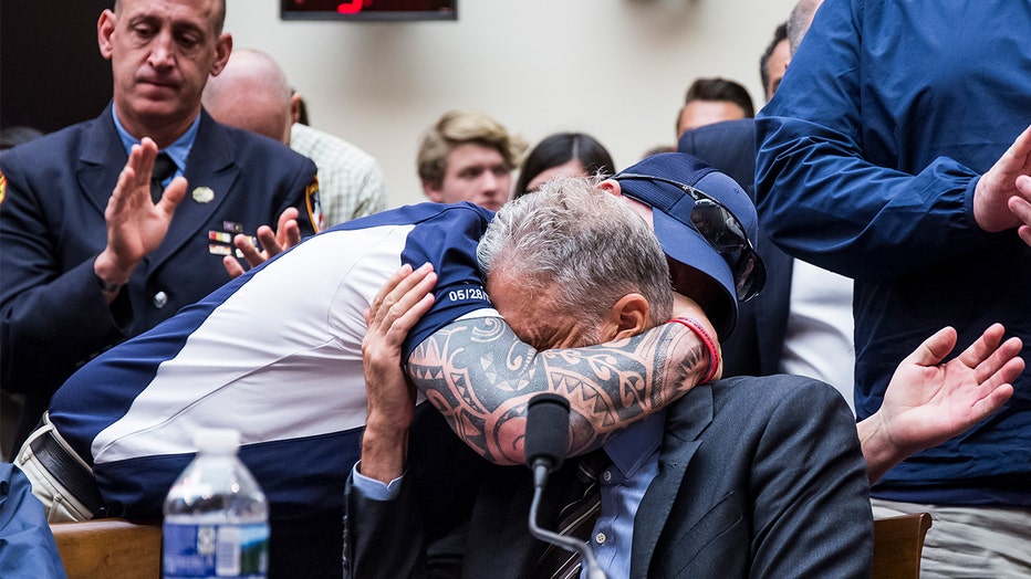 FealGood Foundation co-founder John Feal hugs former Daily Show Host Jon Stewart during a House Judiciary Committee hearing on reauthorization of the 9/11 Victim Compensation Fund on Capitol Hill on June 11, 2019.