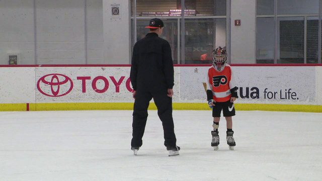 Flyers goalie Carter Hart skates with boy who had partial foot amputation